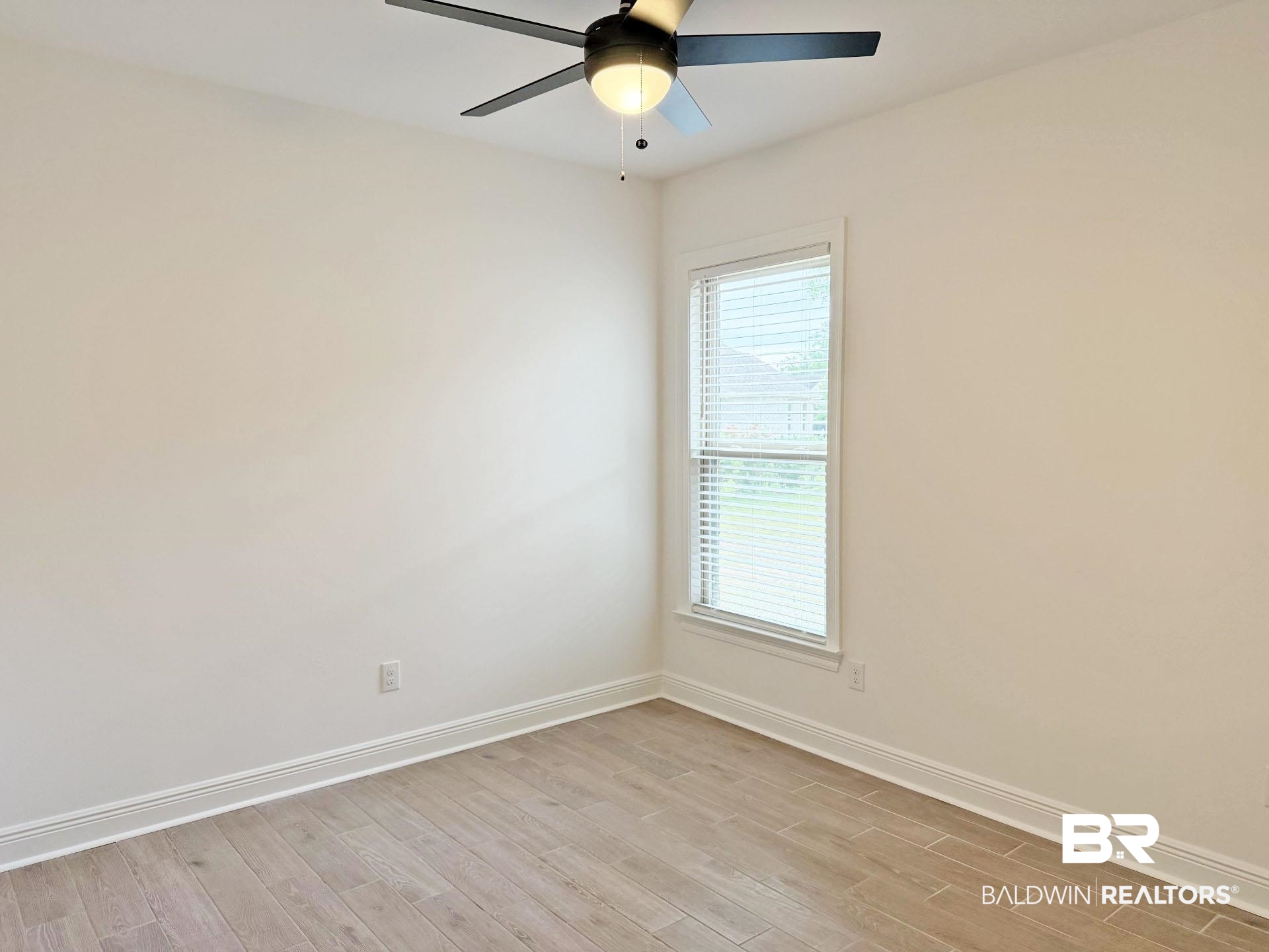 1753 Breckinridge Place Foley, AL 36535 - Photo 18 of 24 Bright room featuring light wood-finish flooring, white baseboards, and a contemporary ceiling fan with integrated lighting