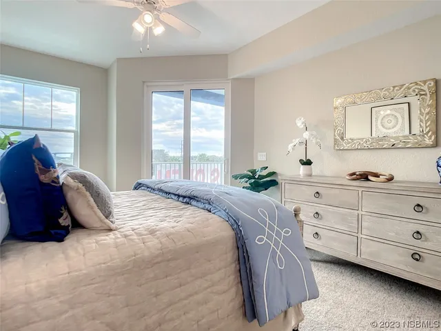 a bedroom with a bed a window and dresser