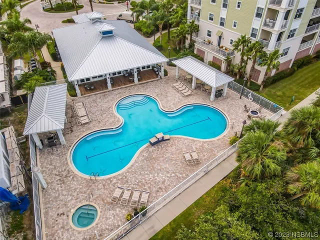 a view of swimming pool outdoor seating and city view