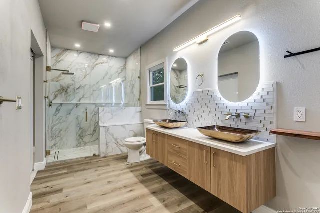 a bathroom with a toilet sink and mirror