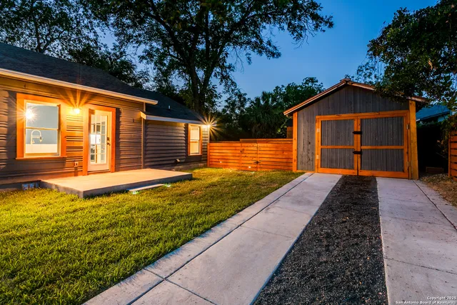 a backyard of a house with a yard and outdoor seating