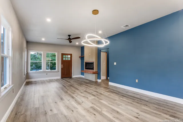 a view of a livingroom with a ceiling fan and window