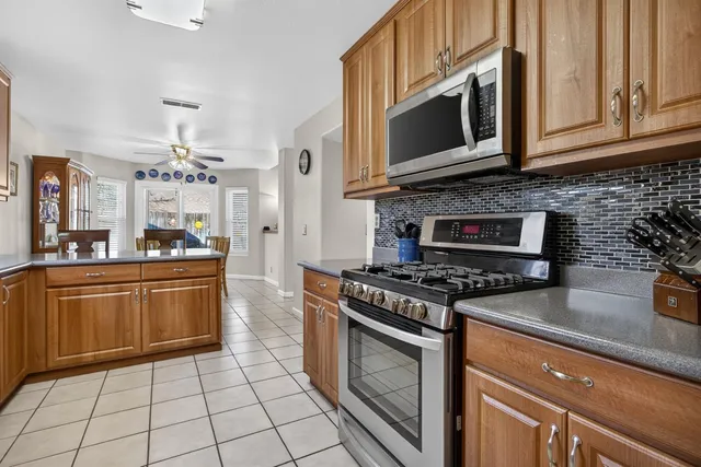 a kitchen with stainless steel appliances a refrigerator and cabinets