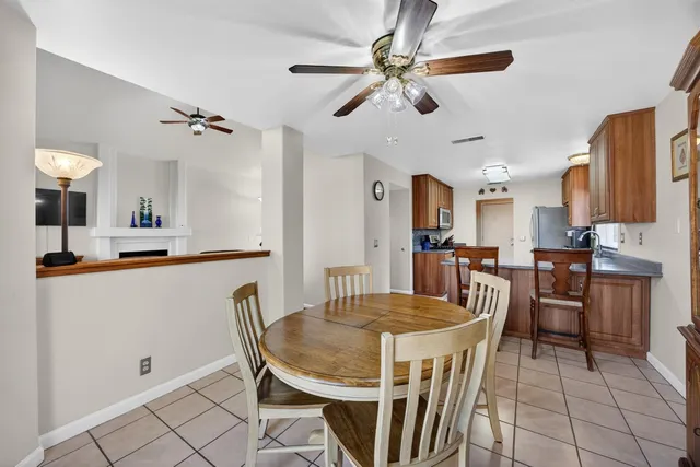 a view of workspace with wooden floor and a ceiling fan