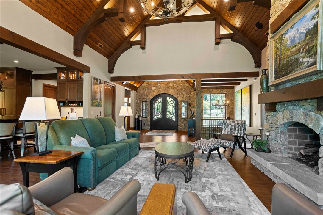 236 Palmer Way Sunset, SC 29685 - Photo 4 of 46 Architectural splendor unfolds in this great room, where a stone fireplace anchors the soaring beamed and vaulted ceilings.