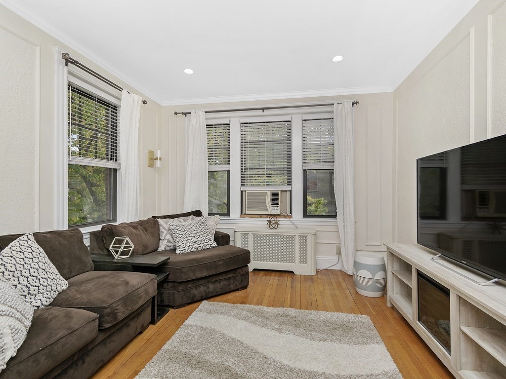 31 Winslow Road, Unit 6 Brookline, MA 02446 - Photo 2 of 18 a living room with furniture and a flat screen tv