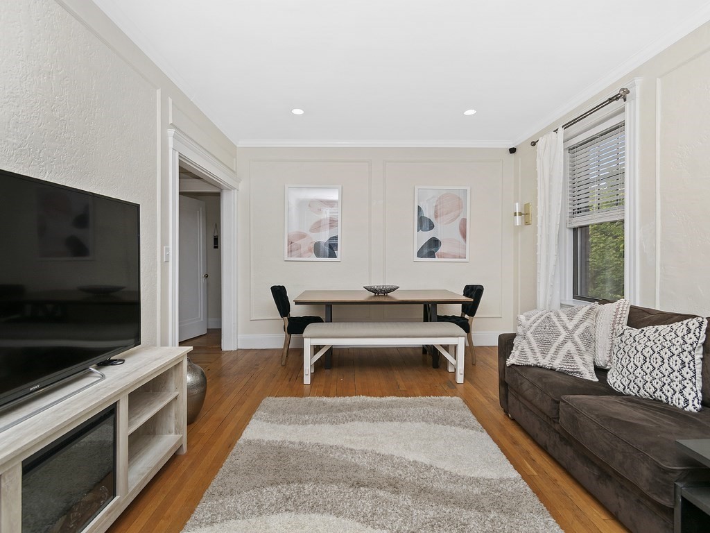 31 Winslow Road, Unit 6 Brookline, MA 02446 - Photo 3 of 18 a living room with furniture and a flat screen tv