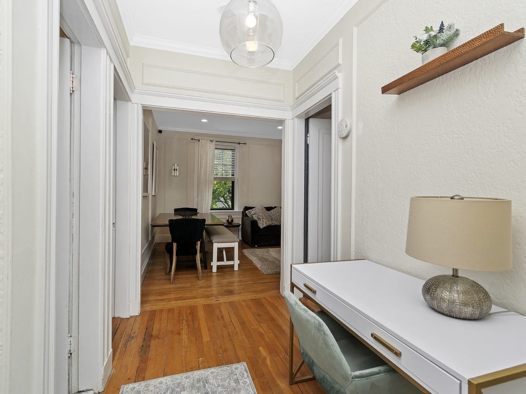 31 Winslow Road, Unit 6 Brookline, MA 02446 - Photo 7 of 18 a dining room with furniture and a chandelier