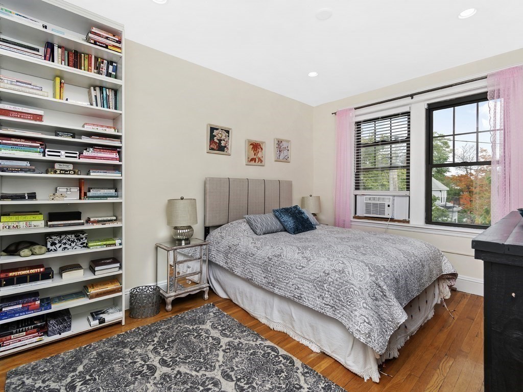 31 Winslow Road, Unit 6 Brookline, MA 02446 - Photo 10 of 18 a bedroom with a bed a dresser and a large window