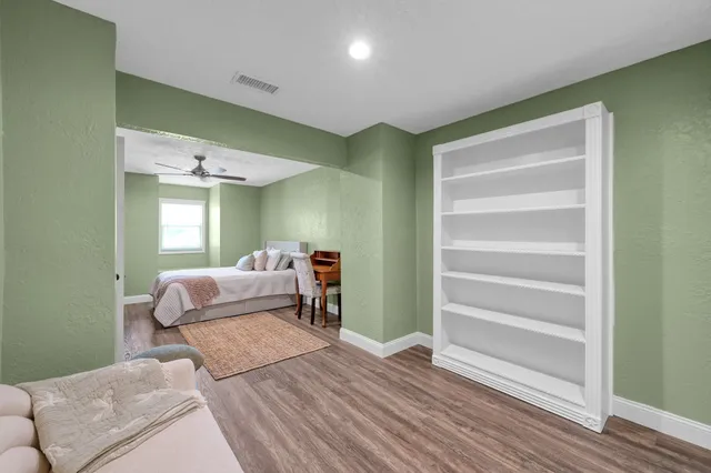 a bedroom with a bed and chair