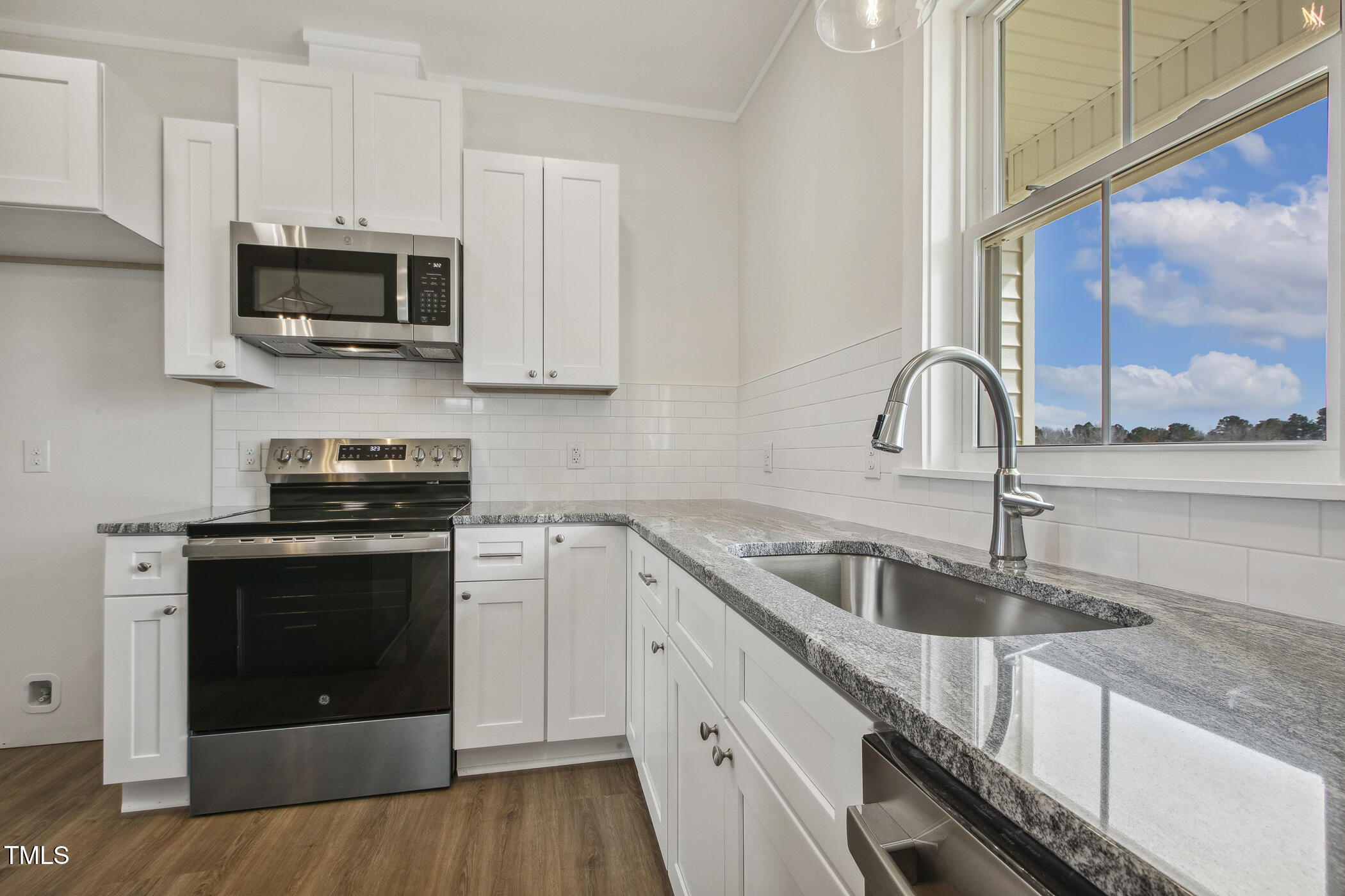 233 Surles Road Benson, NC 27504 - Photo 19 of 57 a kitchen with granite countertop a stove and a sink