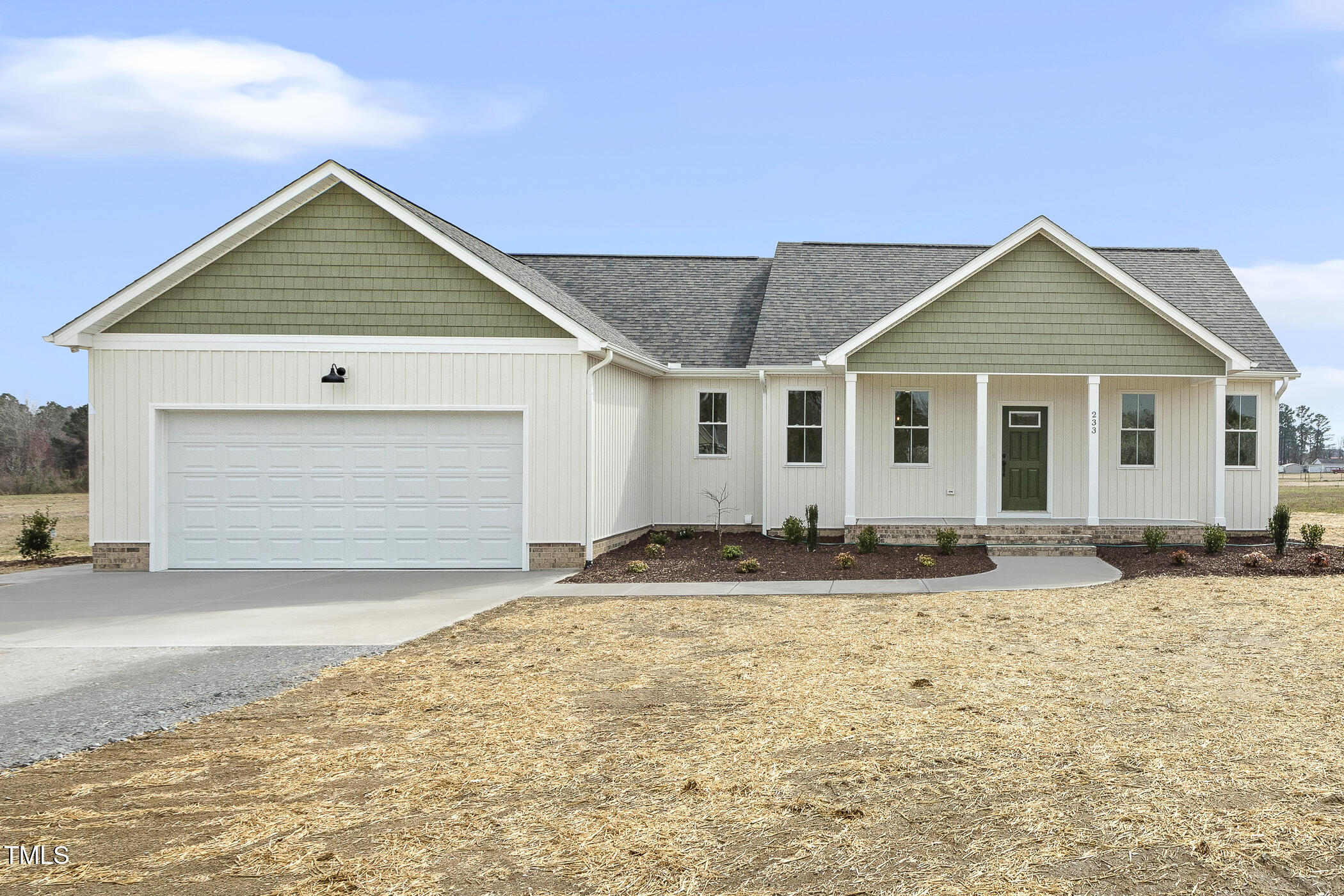 233 Surles Road Benson, NC 27504 - Photo 2 of 57 a front view of a house with a yard and garage
