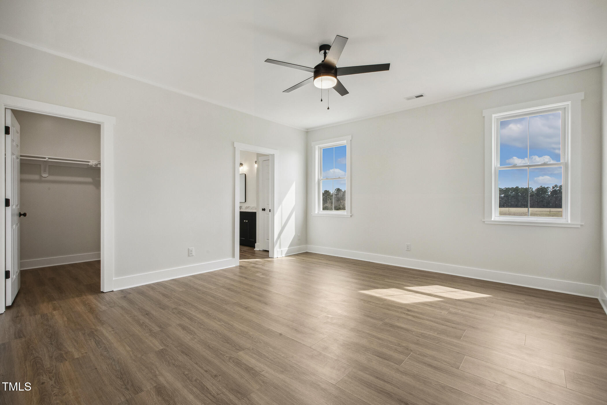233 Surles Road Benson, NC 27504 - Photo 27 of 57 a view of an empty room with wooden floor and a ceiling fan