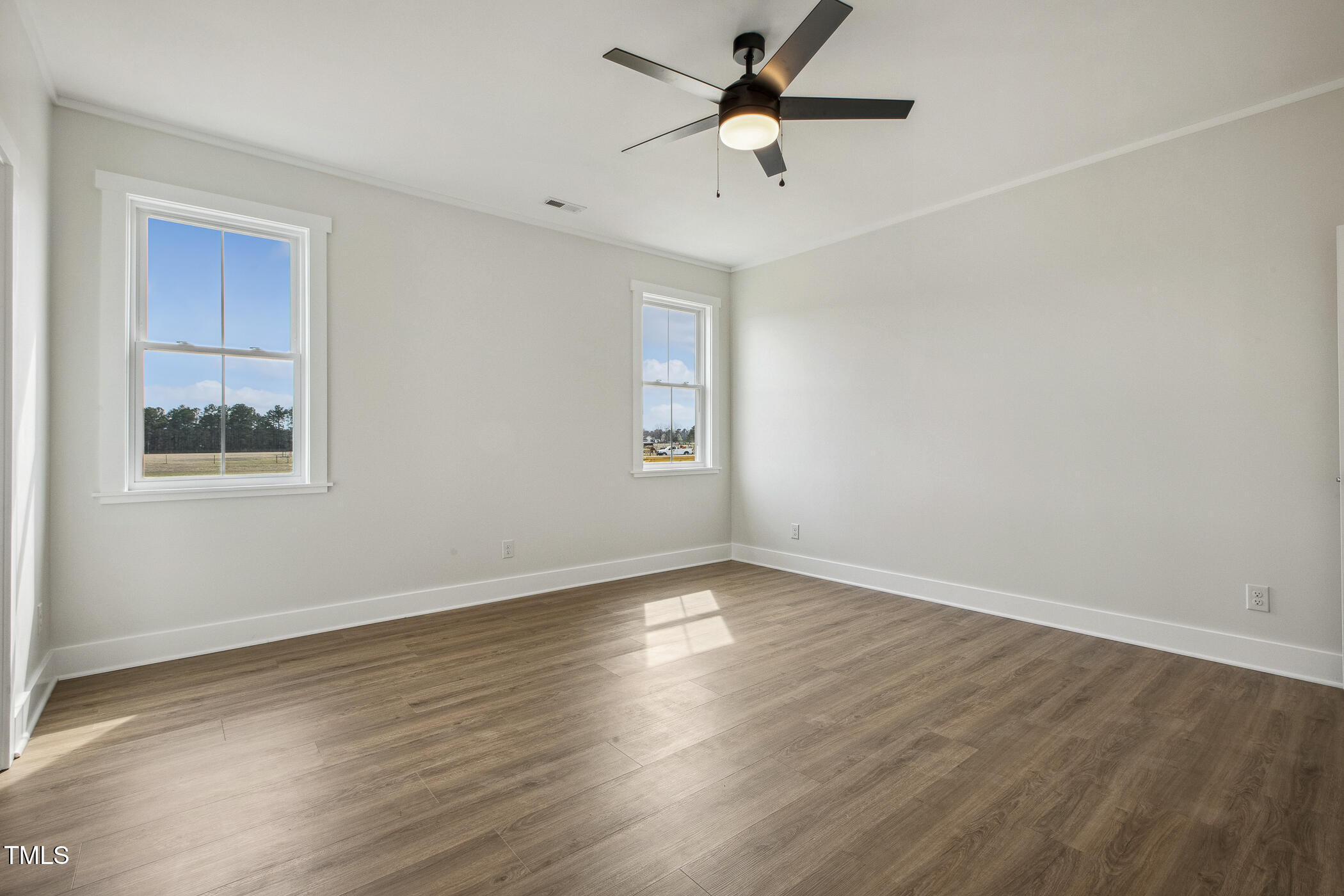 233 Surles Road Benson, NC 27504 - Photo 30 of 57 a view of empty room with wooden floor and fan