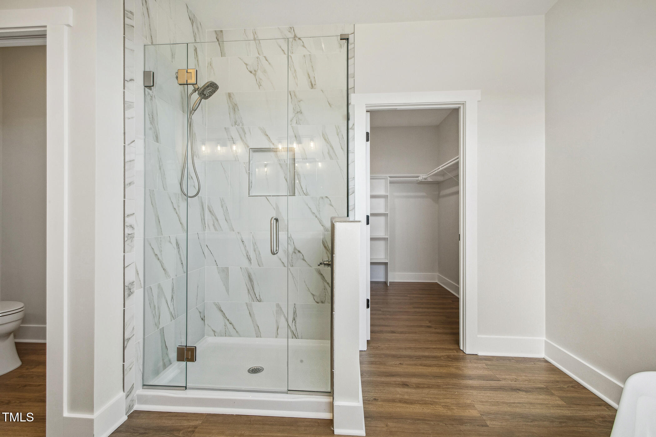 233 Surles Road Benson, NC 27504 - Photo 33 of 57 a bathroom with a glass shower door and a bathtub