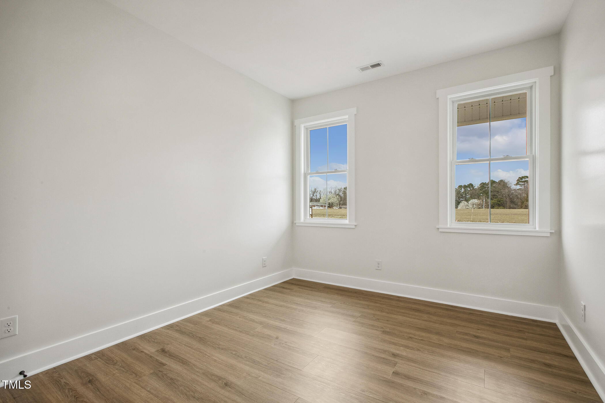 233 Surles Road Benson, NC 27504 - Photo 37 of 57 a view of empty room with wooden floor and fan