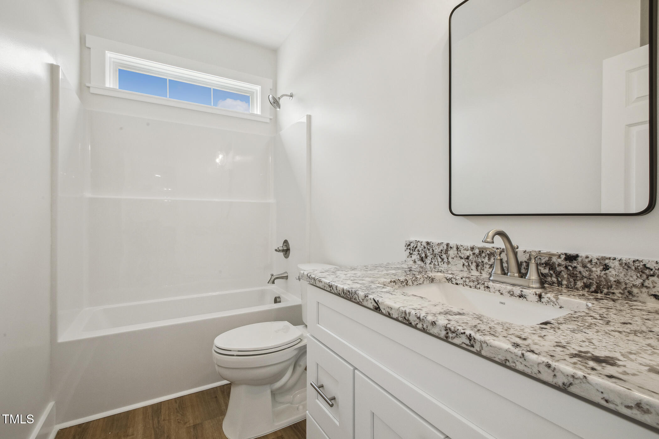 233 Surles Road Benson, NC 27504 - Photo 39 of 57 a bathroom with a granite countertop sink a toilet and a bathtub