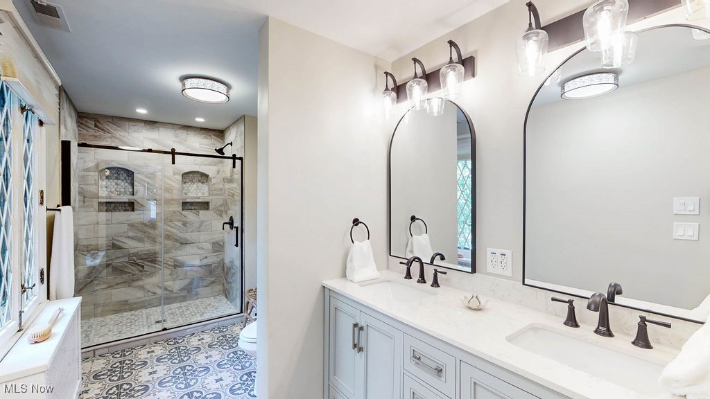 3077 Huntington Road Cleveland, OH 44120 - Photo 18 of 37 Bathroom with double vanity, a stall shower, light tile patterned floors, and recessed lighting