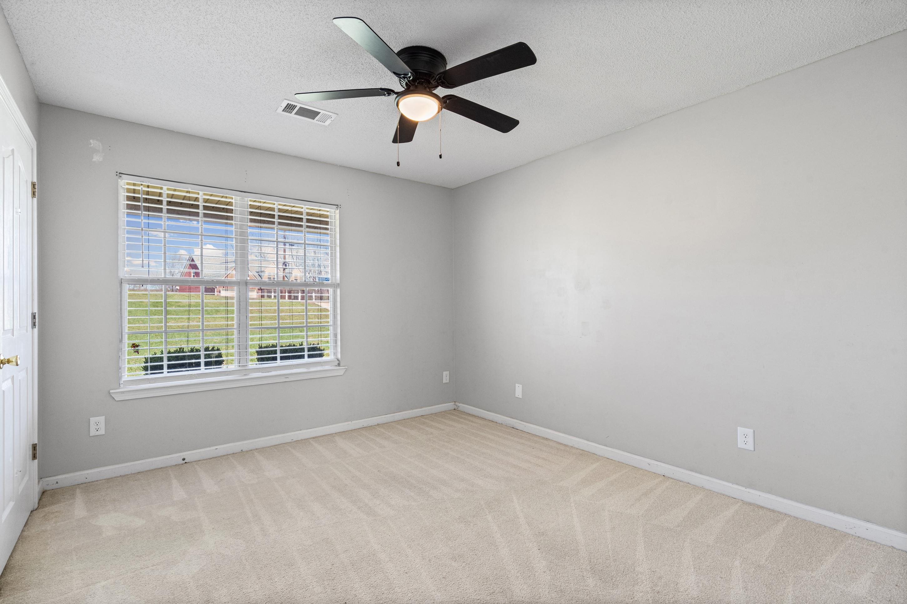 511 Rae Drive Munford, TN 38058 - Photo 14 of 30 an empty room with a window and a fan