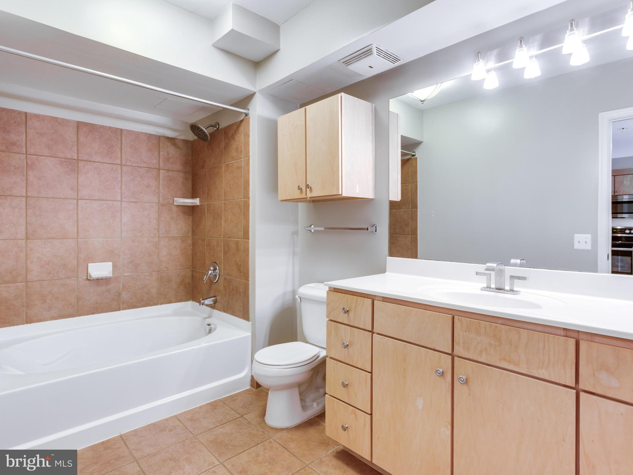 631 D Street Northwest, Unit 837 Washington, DC 20004 - Photo 18 of 29 a bathroom with a sink a toilet and bathtub