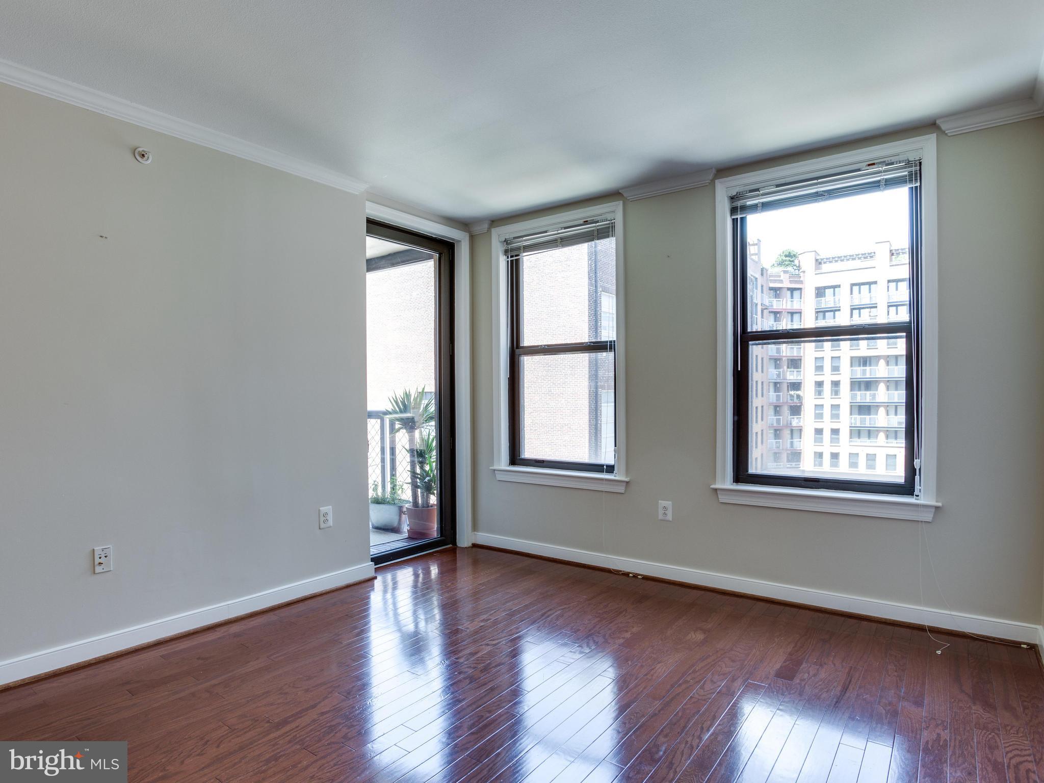 631 D Street Northwest, Unit 837 Washington, DC 20004 - Photo 8 of 29 an empty room with wooden floor and windows
