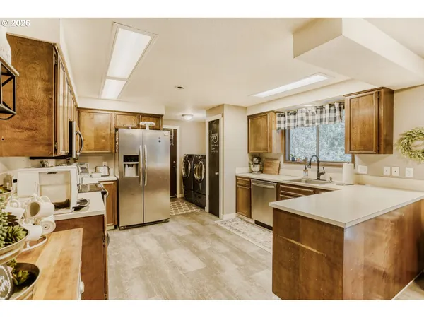 a kitchen with stainless steel appliances kitchen island a sink stove and refrigerator