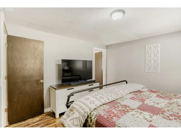 a bedroom with a bed and a flat screen tv