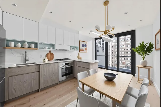 a kitchen with a table chairs sink and cabinets