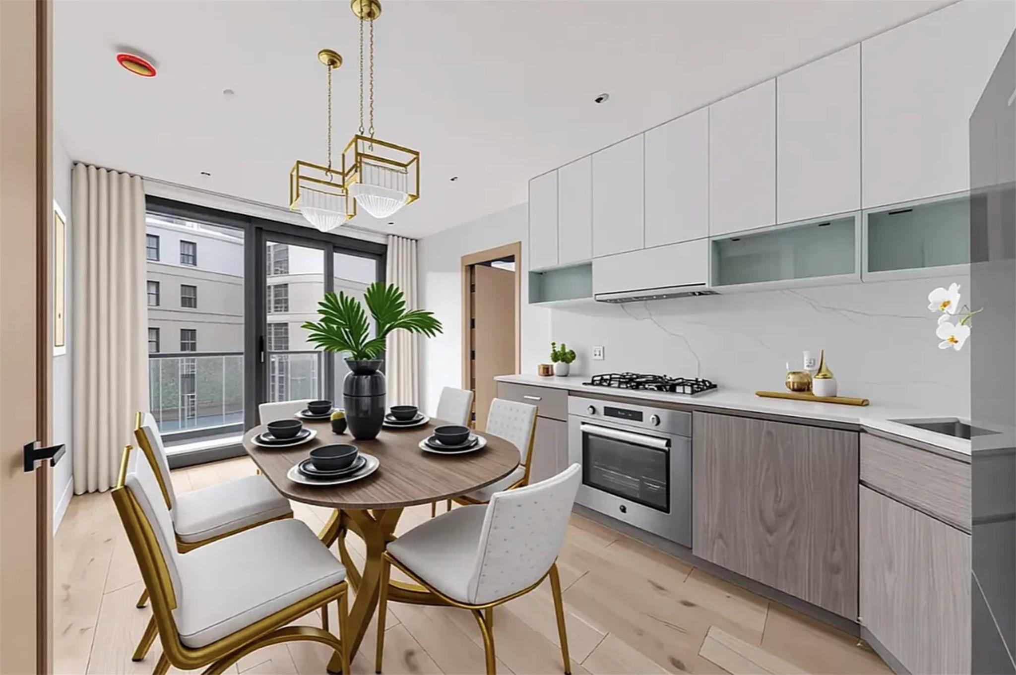 42-62 Hunter Street, Unit 3C Queens, NY 11101 - Photo 4 of 11 a kitchen with stainless steel appliances a table and chairs in it