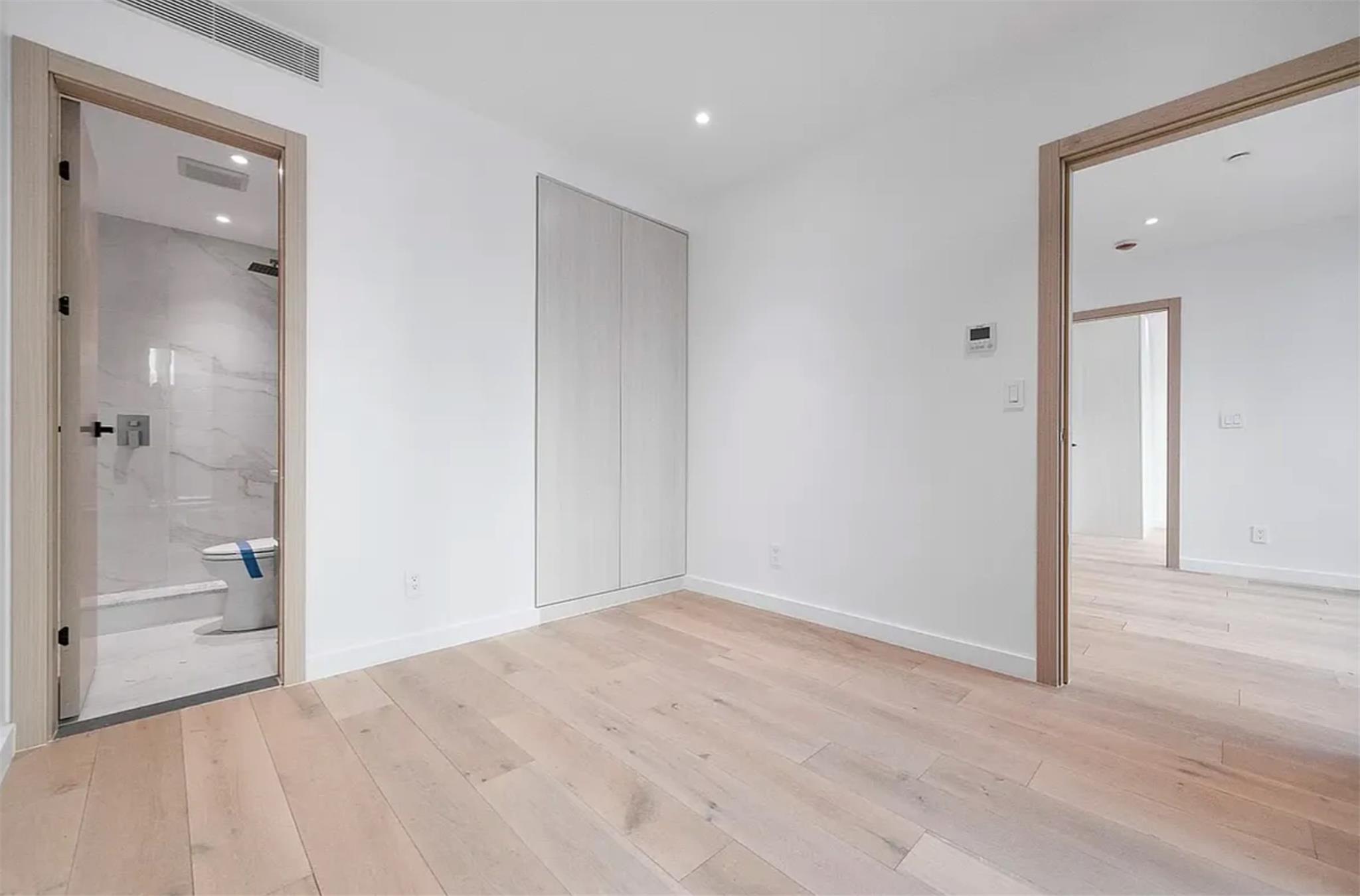 42-62 Hunter Street, Unit 3C Queens, NY 11101 - Photo 5 of 11 a bathroom with a shower and a glass door