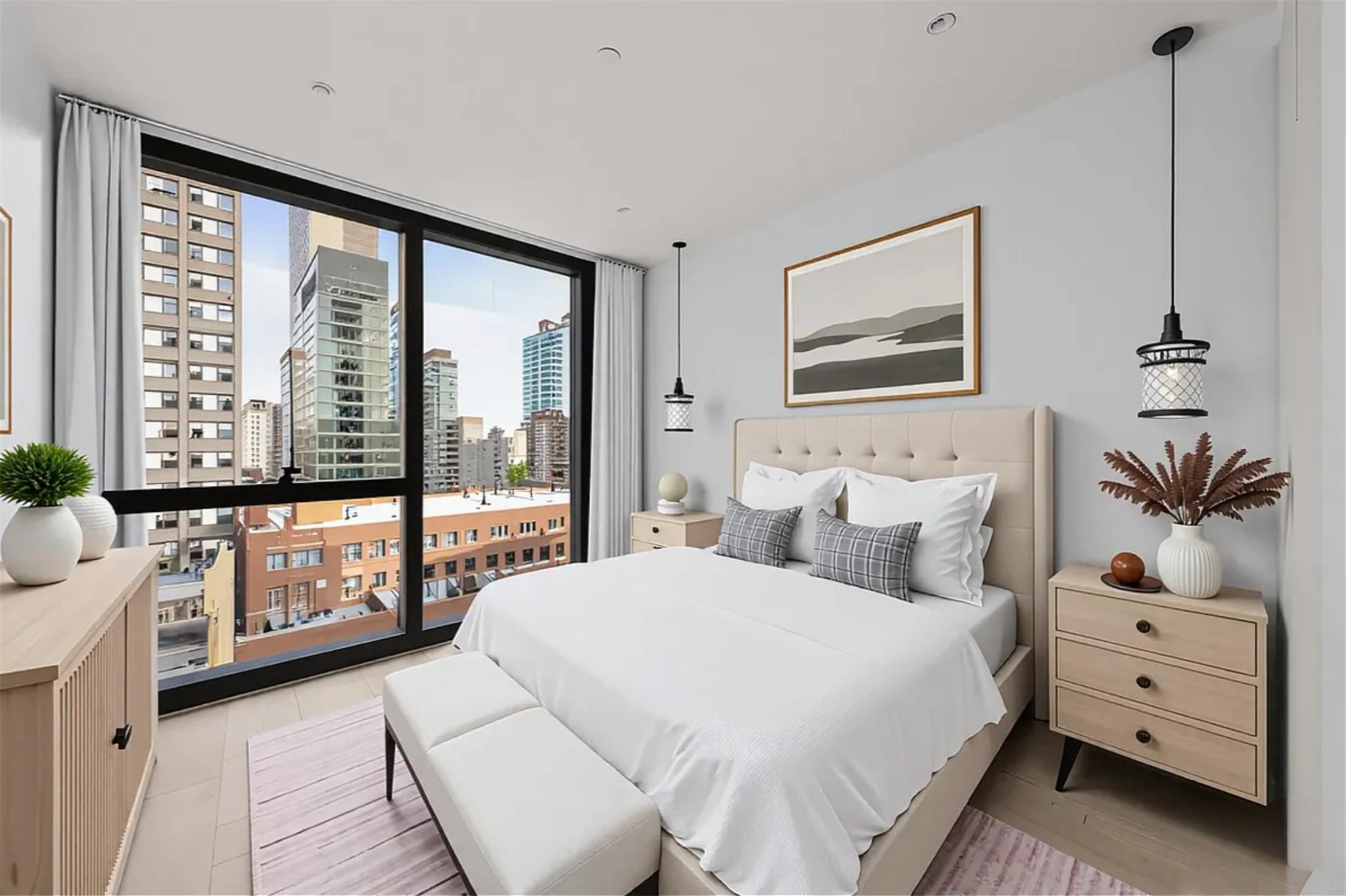 42-62 Hunter Street, Unit 3C Queens, NY 11101 - Photo 7 of 11 a bedroom with a large bed and a window