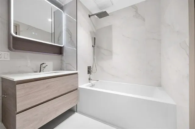 a bathroom with a bathtub and a sink