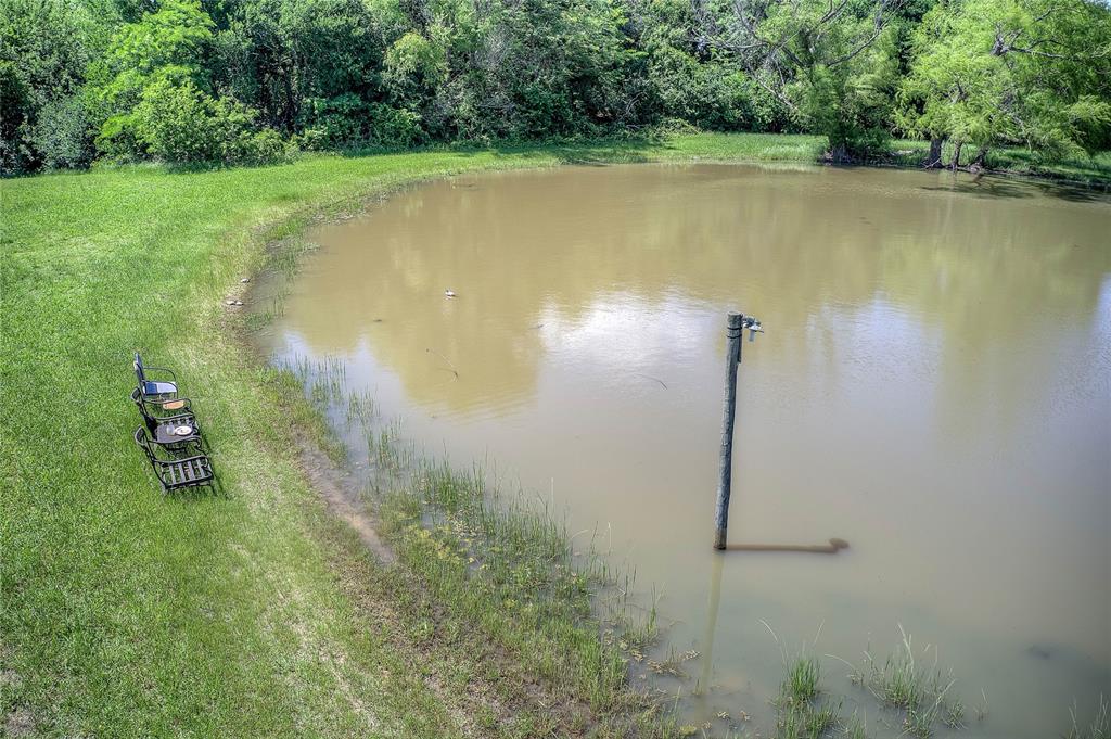 5101 Pecan Creek Road Celeste, TX 75423 - Photo 17 of 23 a view of a lake with a yard and trees
