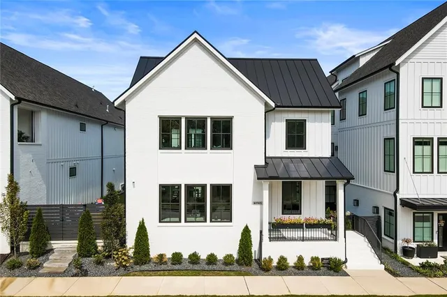 a view of a white building with large windows