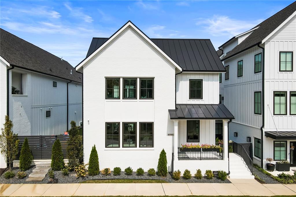 6715 Halcyon Way Alpharetta, GA 30005 - Photo 1 of 60 a view of a white building with large windows