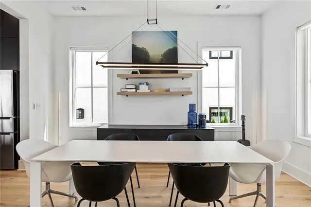 a living room with furniture a flat screen tv and kitchen view