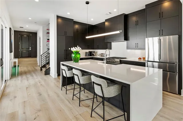 a kitchen with a sink stove and cabinets