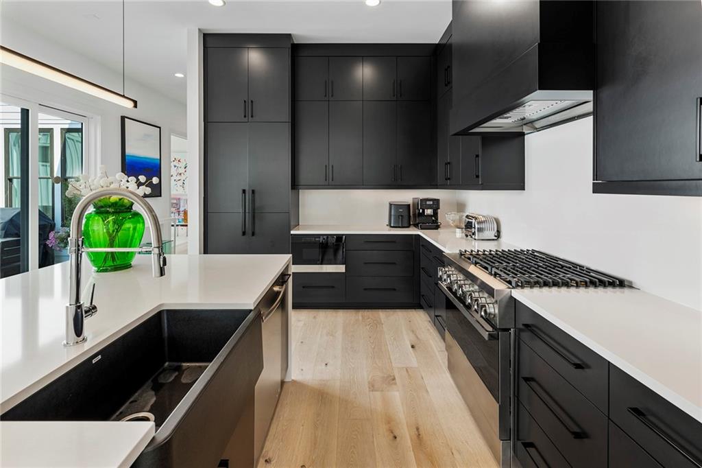 6715 Halcyon Way Alpharetta, GA 30005 - Photo 17 of 60 a kitchen with a sink stove and cabinets