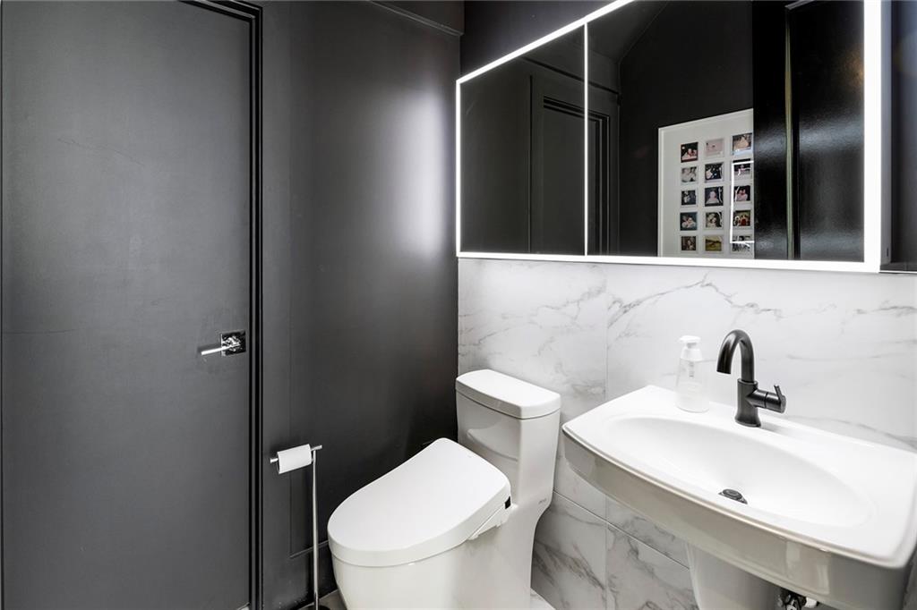 6715 Halcyon Way Alpharetta, GA 30005 - Photo 22 of 60 a bathroom with a toilet sink and mirror