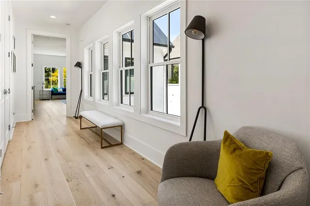 a living room with furniture a large window and a flat screen tv