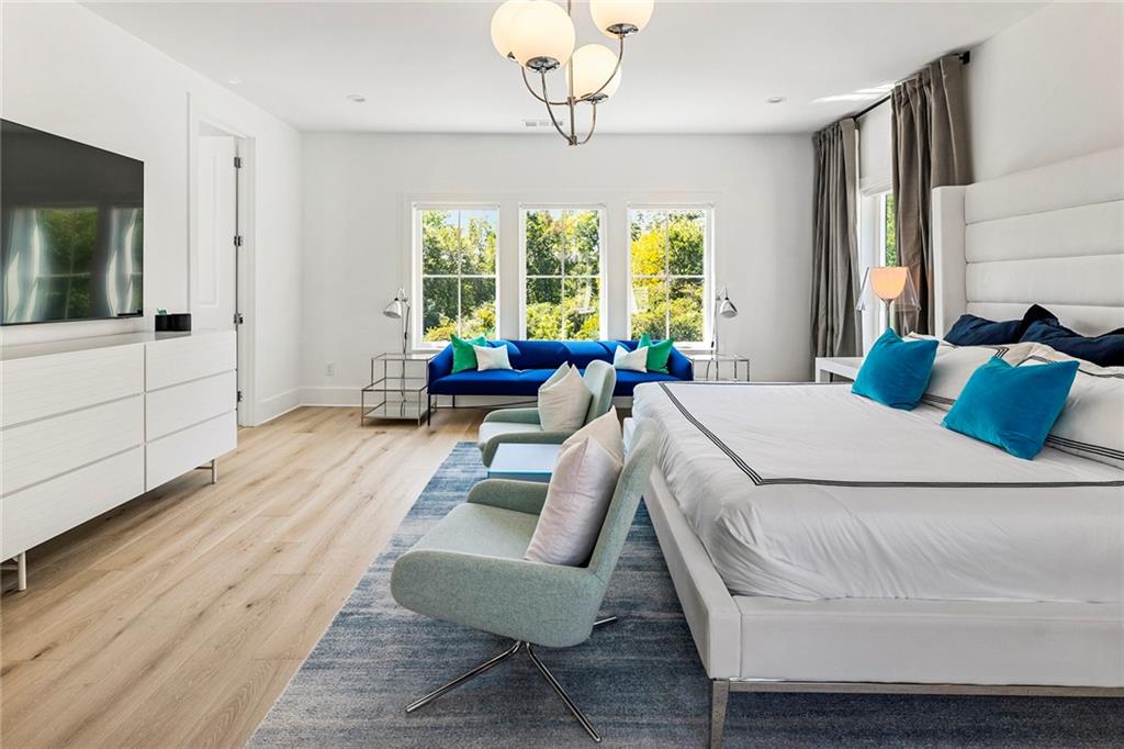 6715 Halcyon Way Alpharetta, GA 30005 - Photo 26 of 60 a bed room with a bed and a chandelier