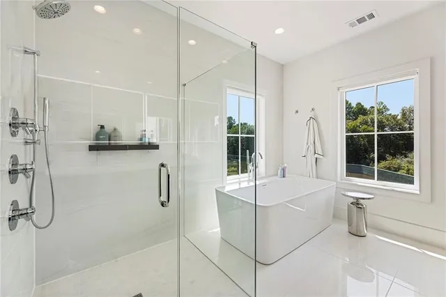 a bathroom with a sink vanity tub and a mirror