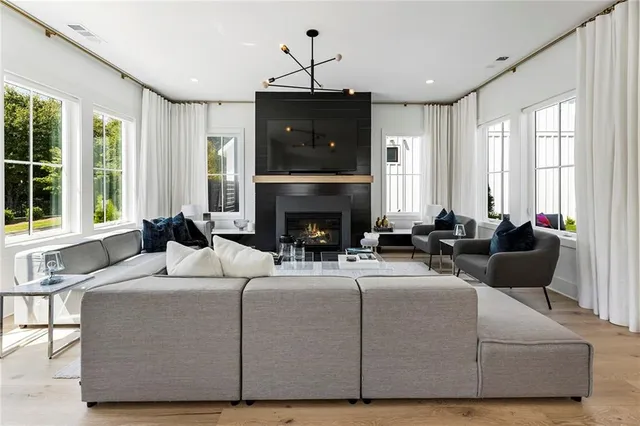 a living room with furniture fireplace and flat screen tv
