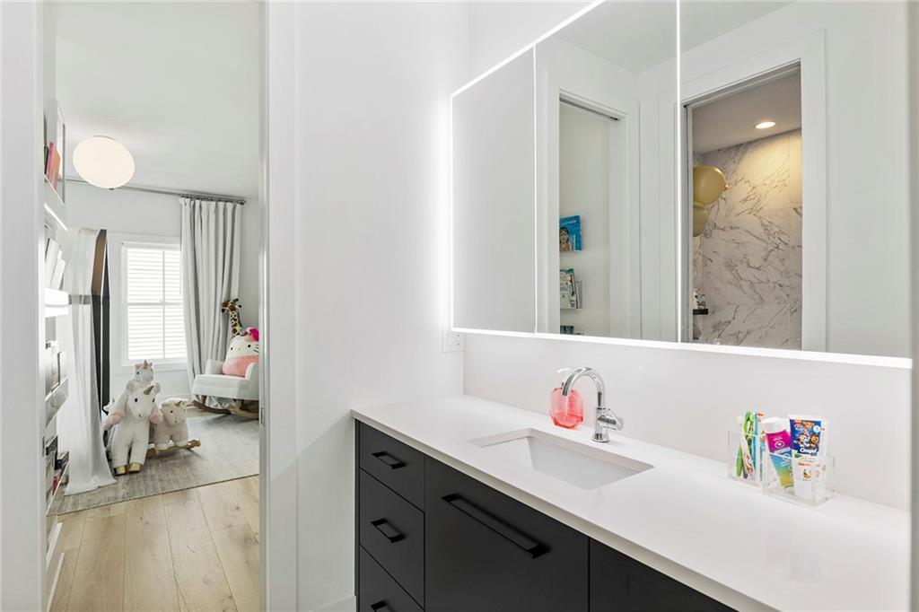 6715 Halcyon Way Alpharetta, GA 30005 - Photo 34 of 60 a bathroom with a sink vanity tub and a mirror