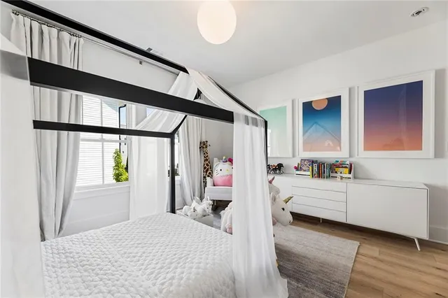 a living room with furniture kitchen view and a window