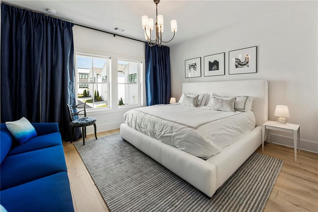 6715 Halcyon Way Alpharetta, GA 30005 - Photo 38 of 60 a bedroom with bed and a couch