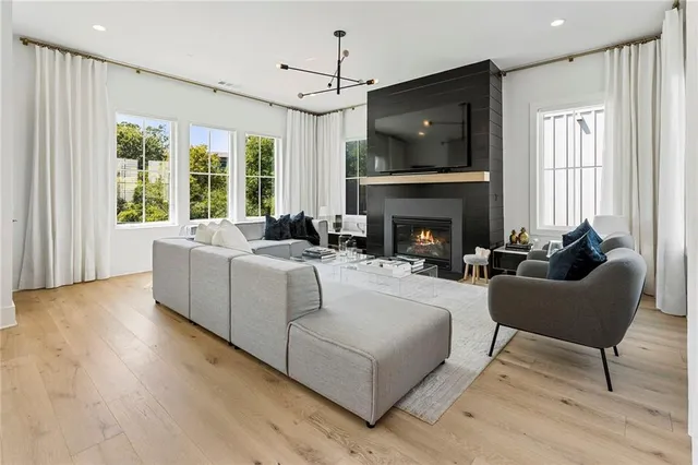 a living room with furniture a flat screen tv and a fireplace