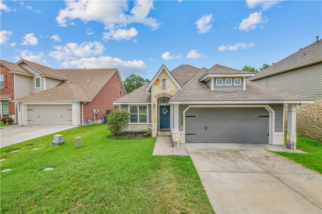 3014 Positano Loop Bryan, TX 77808 - Photo 1 of 23 a front view of a house with a garden and yard