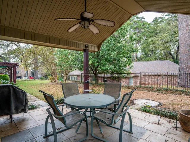 a view of a patio with table and chairs under an umbrella