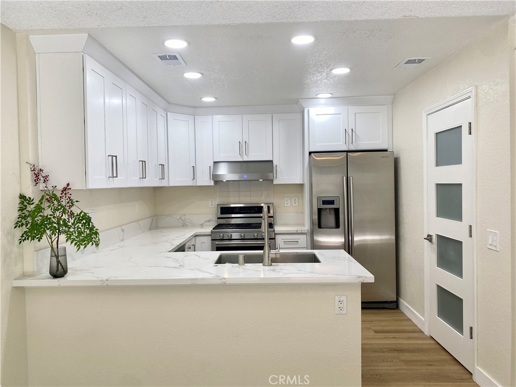 3 Cll Del Rey Phillips Ranch, CA 91766 - Photo 3 of 25 a kitchen with stainless steel appliances a refrigerator sink and cabinets